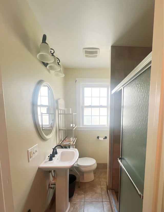 full bathroom with toilet, tile patterned floors, visible vents, and a shower stall