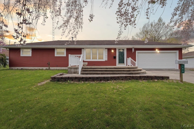 ranch-style home featuring concrete driveway, a yard, and a garage
