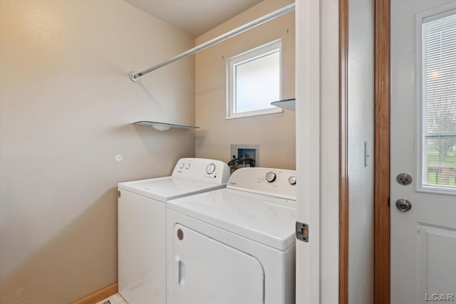 laundry area featuring washing machine and clothes dryer, laundry area, and baseboards