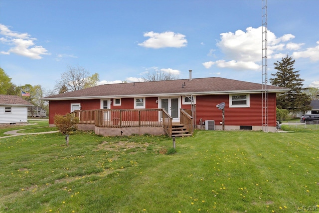 rear view of house with a lawn, a deck, and french doors