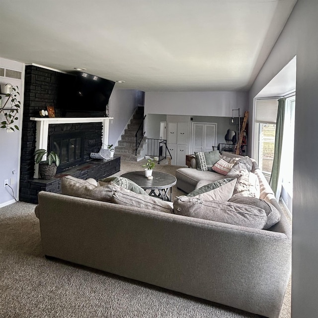 613 E Rolston, Linden, MI 48415 - living area featuring carpet, stairway, and a fireplace