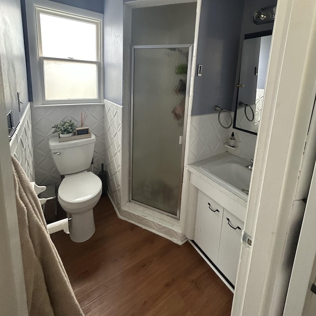 613 E Rolston, Linden, MI 48415 - bathroom featuring tile walls, a shower stall, vanity, and wood finished floors
