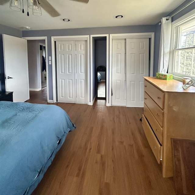 613 E Rolston, Linden, MI 48415 - bedroom with ceiling fan, dark wood finished floors, baseboards, two closets, and recessed lighting
