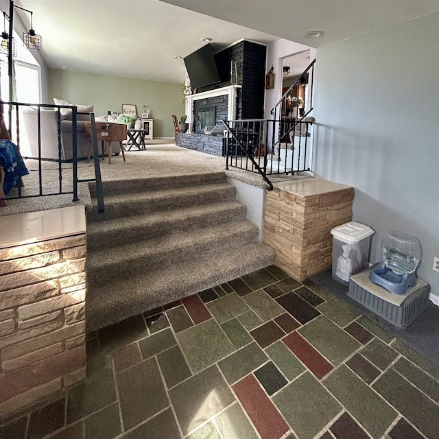 613 E Rolston, Linden, MI 48415 - staircase featuring a brick fireplace