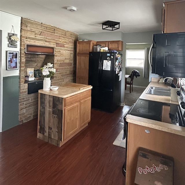 613 E Rolston, Linden, MI 48415 - kitchen with a sink, light countertops, brown cabinetry, dark wood-style floors, and black appliances