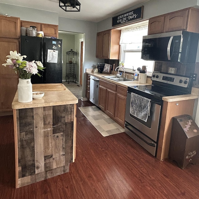 613 E Rolston, Linden, MI 48415 - kitchen featuring dark wood-style flooring, brown cabinets, a sink, light countertops, and stainless steel appliances