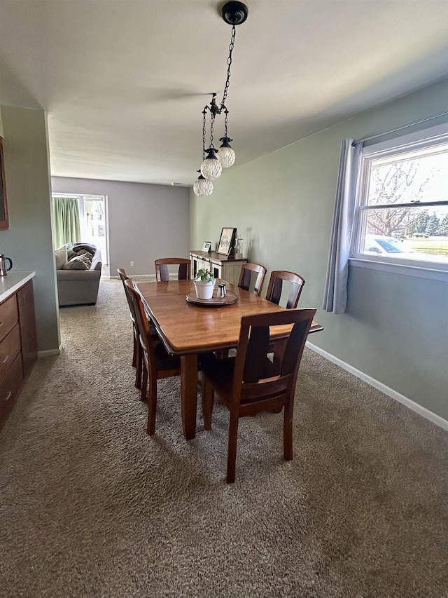 613 E Rolston, Linden, MI 48415 - dining room featuring dark carpet, baseboards, and a wealth of natural light
