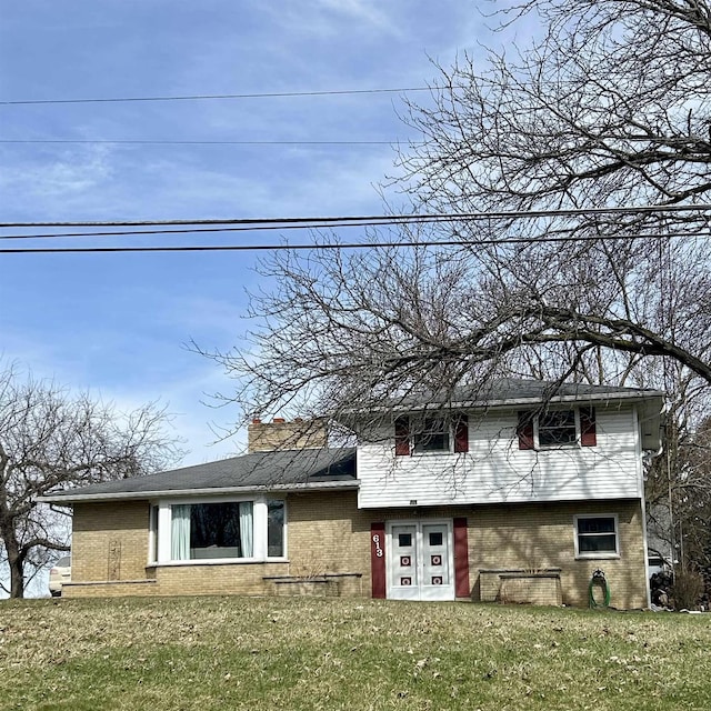 613 E Rolston, Linden, MI 48415 - view of front of home with brick siding and a front lawn