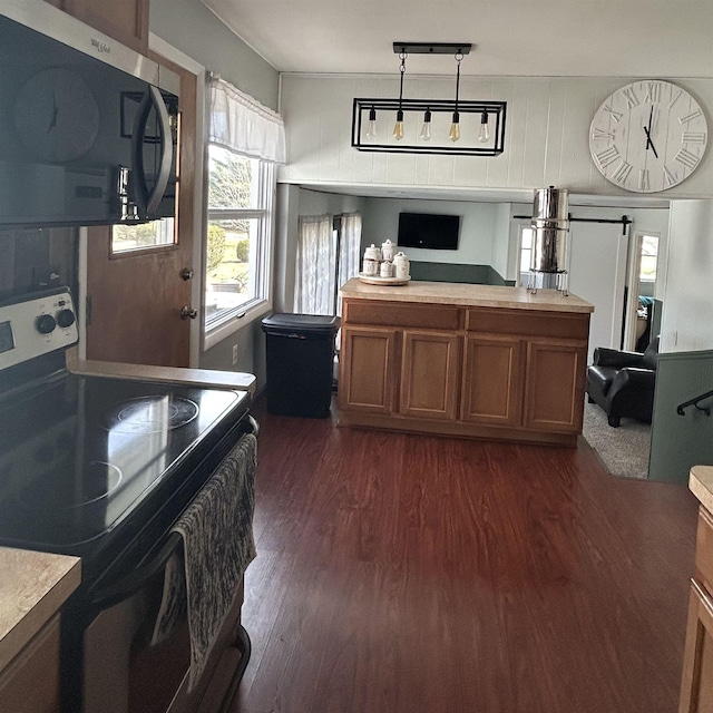 613 E Rolston, Linden, MI 48415 - kitchen featuring electric range oven, brown cabinets, light countertops, stainless steel microwave, and dark wood-style floors