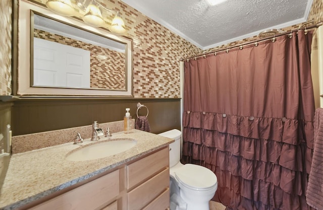 full bathroom with a shower with curtain, a textured ceiling, wainscoting, vanity, and toilet