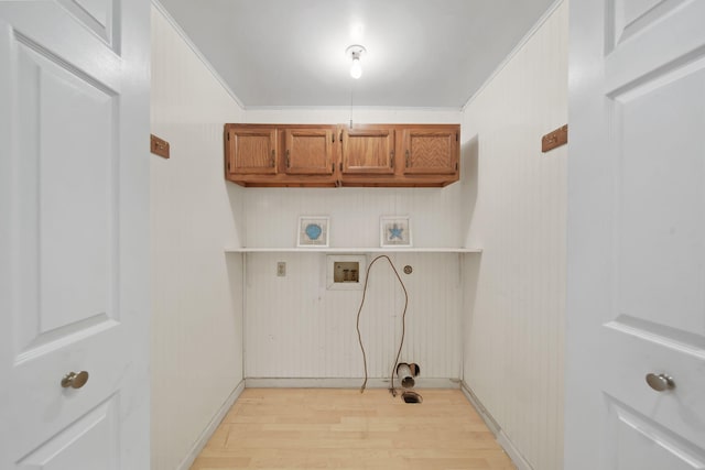 clothes washing area featuring hookup for an electric dryer, light wood-style flooring, hookup for a washing machine, and cabinet space