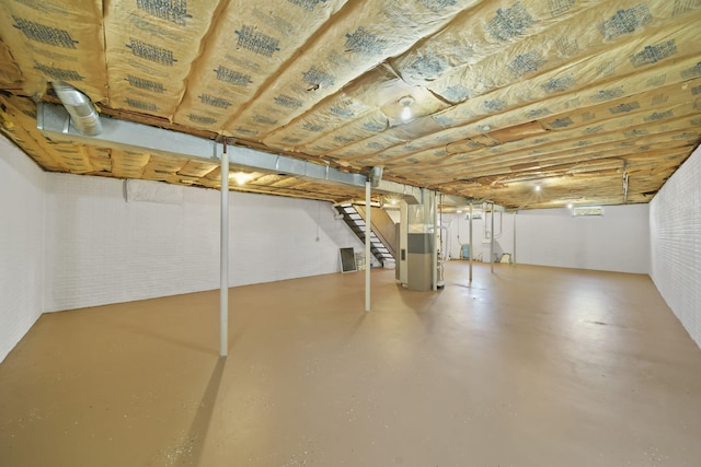 below grade area with stairs and heating unit