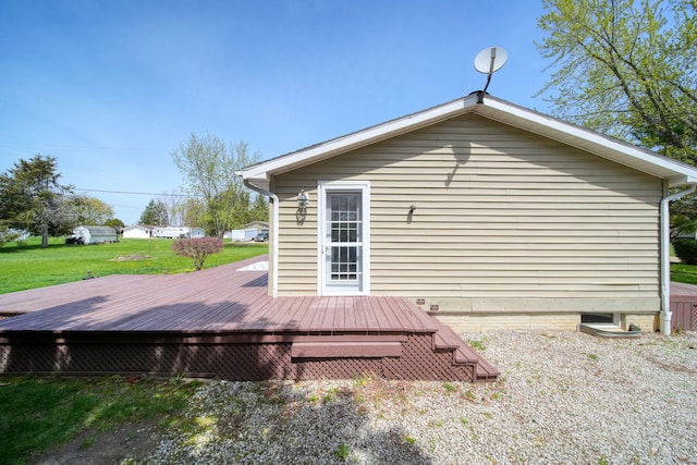 rear view of property with a lawn and a deck