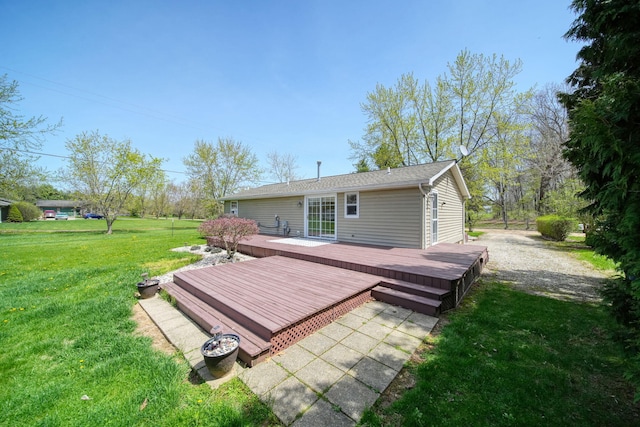 back of property featuring a lawn and a wooden deck