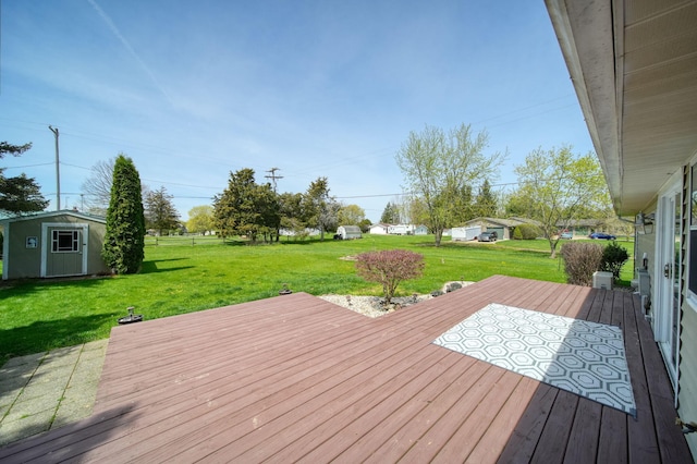 deck with an outdoor structure, a lawn, and a storage shed