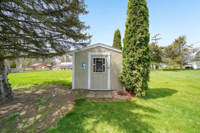 view of shed featuring fence