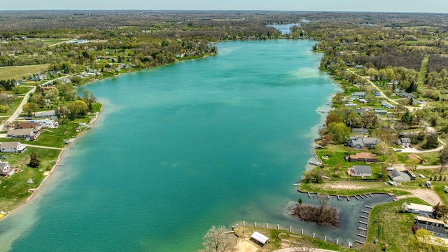 aerial view featuring a water view and a wooded view