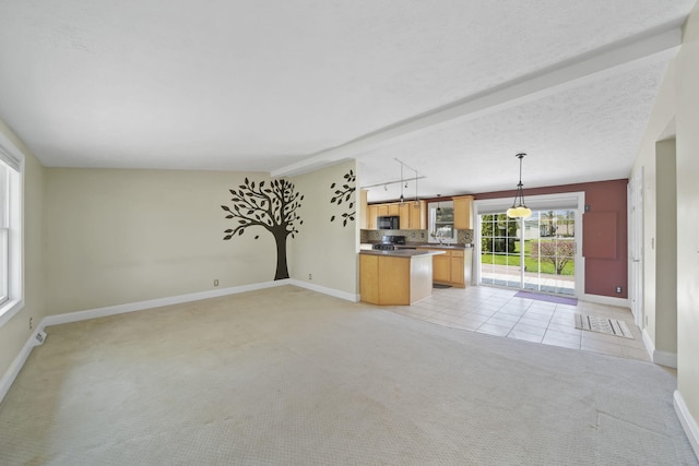 unfurnished living room with light colored carpet, baseboards, and light tile patterned floors