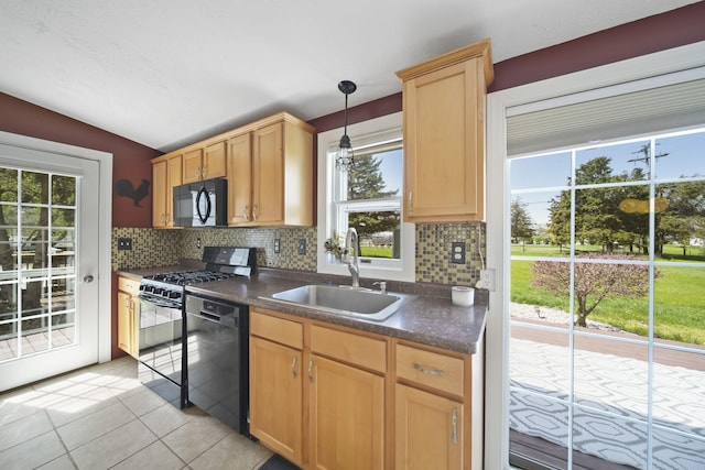 kitchen with dark countertops, a sink, lofted ceiling, tasteful backsplash, and black appliances