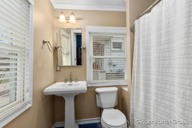 bathroom with crown molding, toilet, and a shower with shower curtain