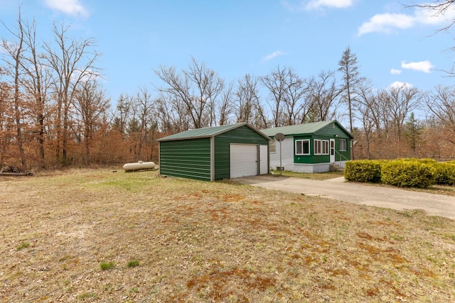 view of property exterior featuring a lawn, driveway, and a garage