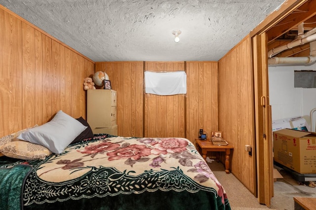 carpeted bedroom featuring wooden walls and a textured ceiling