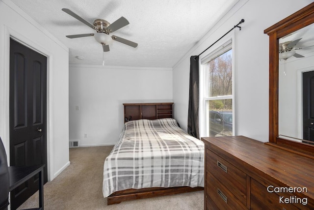 bedroom with visible vents, a ceiling fan, baseboards, a textured ceiling, and carpet flooring