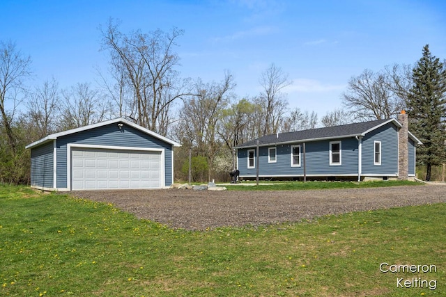 ranch-style house featuring an outdoor structure, a garage, a front lawn, and a chimney