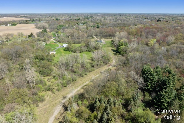 birds eye view of property featuring a view of trees