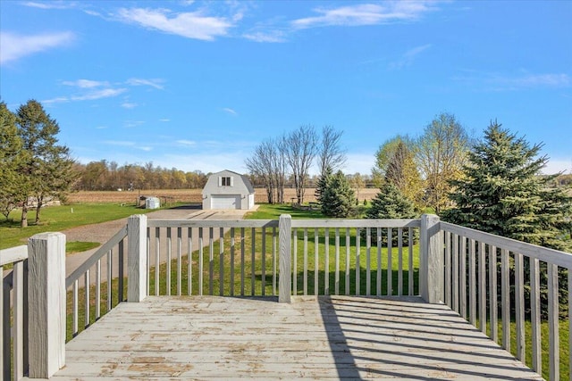 wooden terrace with a yard, an outdoor structure, and a detached garage