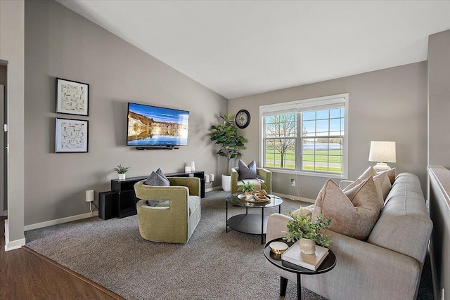 living area with carpet flooring, baseboards, vaulted ceiling, and wood finished floors