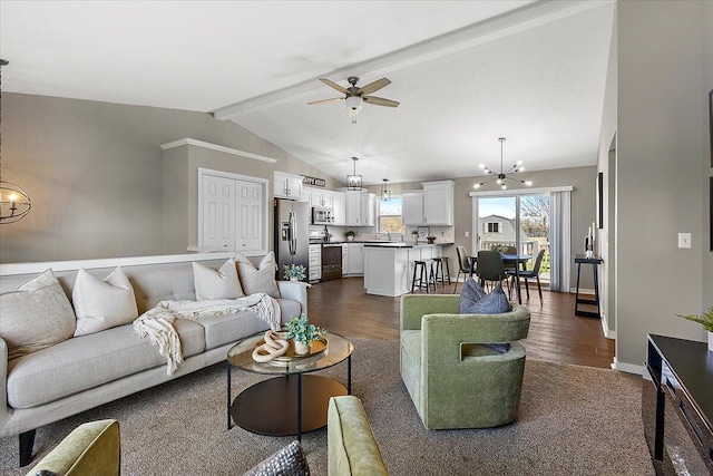 living room featuring baseboards, lofted ceiling with beams, dark wood-style floors, and ceiling fan with notable chandelier