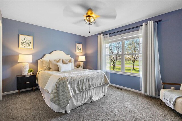 bedroom featuring baseboards, visible vents, ceiling fan, and carpet