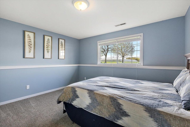 carpeted bedroom with baseboards and visible vents