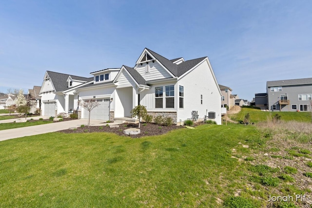 view of front of home with board and batten siding, central AC unit, a front lawn, concrete driveway, and an attached garage