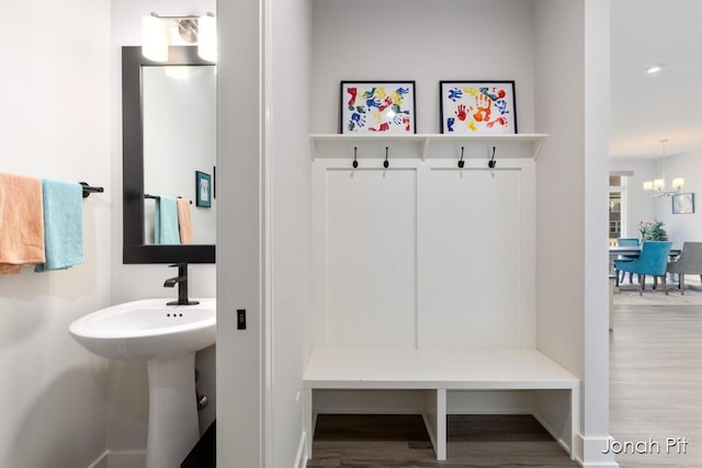 mudroom featuring an inviting chandelier, baseboards, recessed lighting, and wood finished floors
