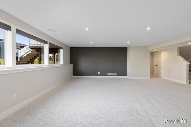 empty room with visible vents, stairs, baseboards, light carpet, and recessed lighting
