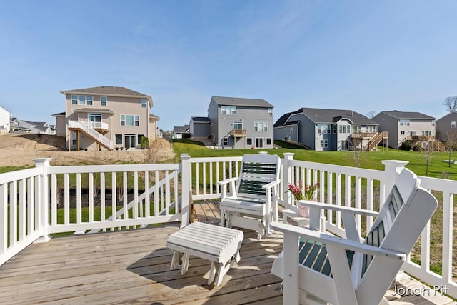 wooden terrace featuring a yard and a residential view