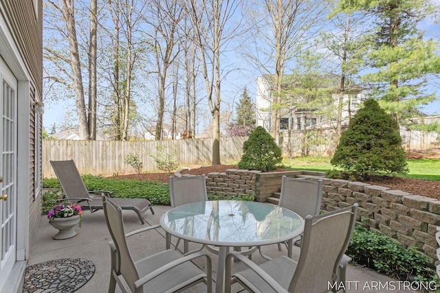 view of patio / terrace featuring outdoor dining area and fence
