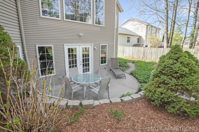 view of patio / terrace featuring fence and french doors