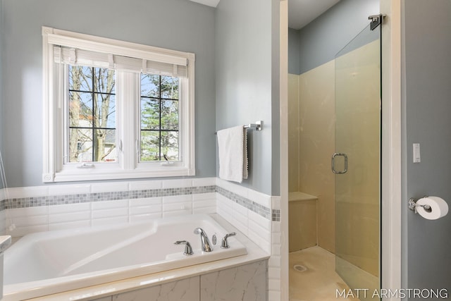 full bathroom with a stall shower and a garden tub