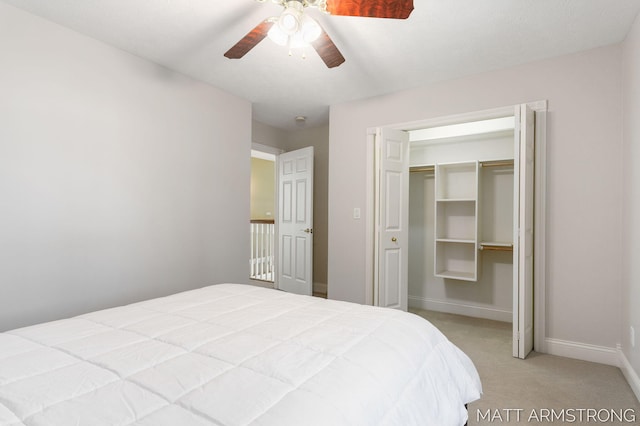 bedroom with baseboards, ceiling fan, a closet, and light colored carpet