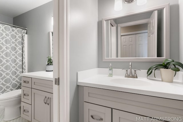 bathroom featuring toilet, curtained shower, and vanity