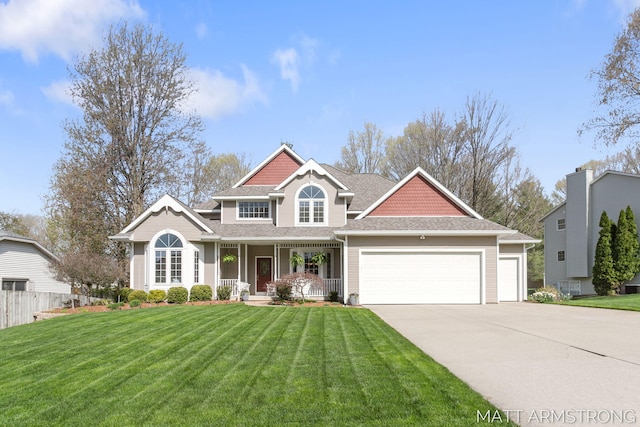 craftsman house featuring fence, an attached garage, a front lawn, covered porch, and driveway
