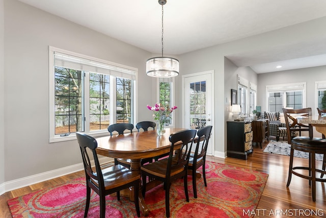 dining space with baseboards, recessed lighting, and wood finished floors