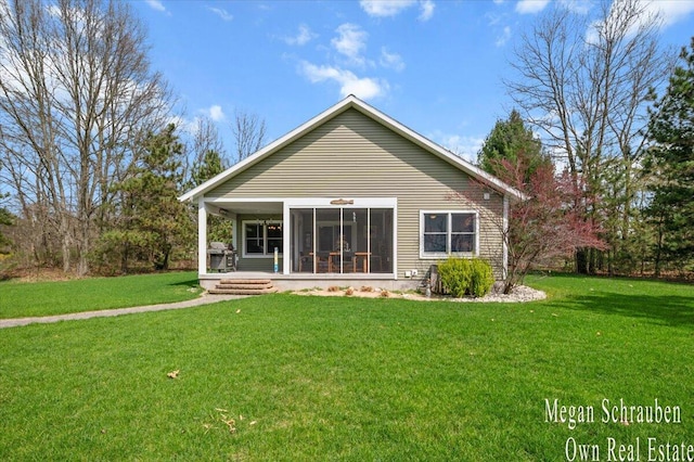 back of house with a lawn and a sunroom