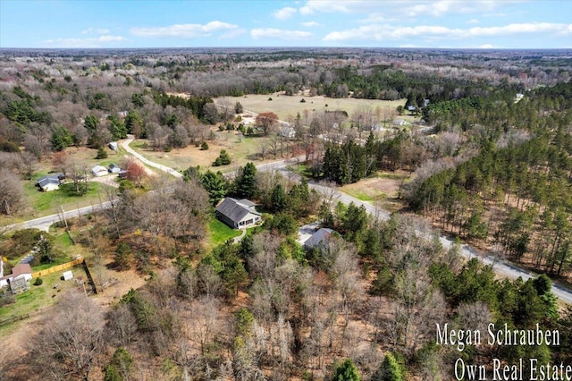 birds eye view of property featuring a wooded view