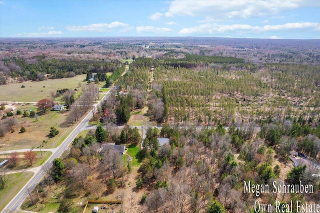 birds eye view of property with a forest view