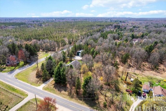 bird's eye view featuring a wooded view