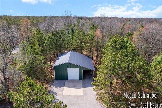 drone / aerial view with a wooded view